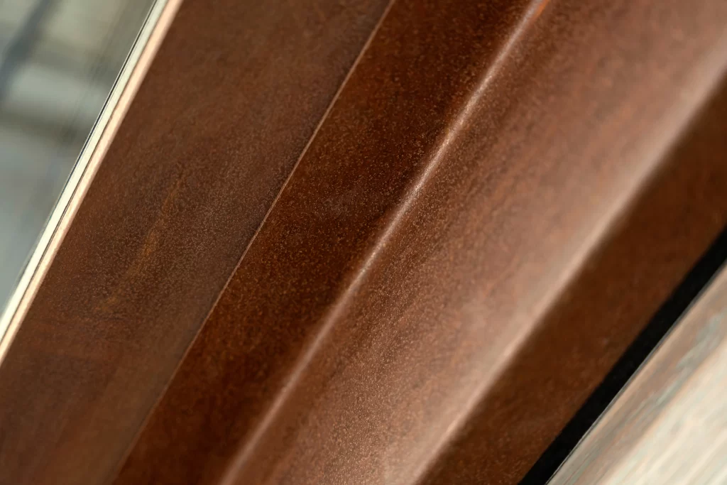 Close-up frame view captures the rich texture of a corten steel surface, showcasing fine craftsmanship and a refined aesthetic.